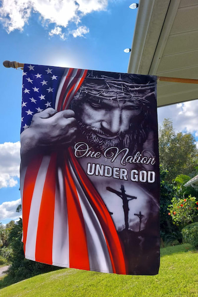 decorative american jesus flag hang on a flagpole under the sun
