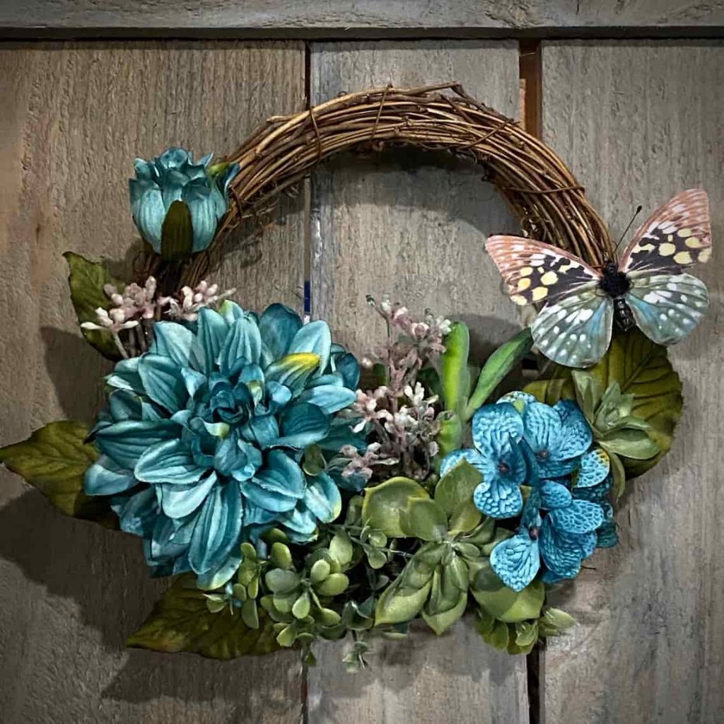 grapevine wreath with blue flowers