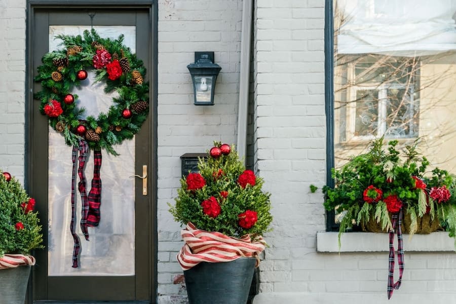 christmas plannters at front door of a house