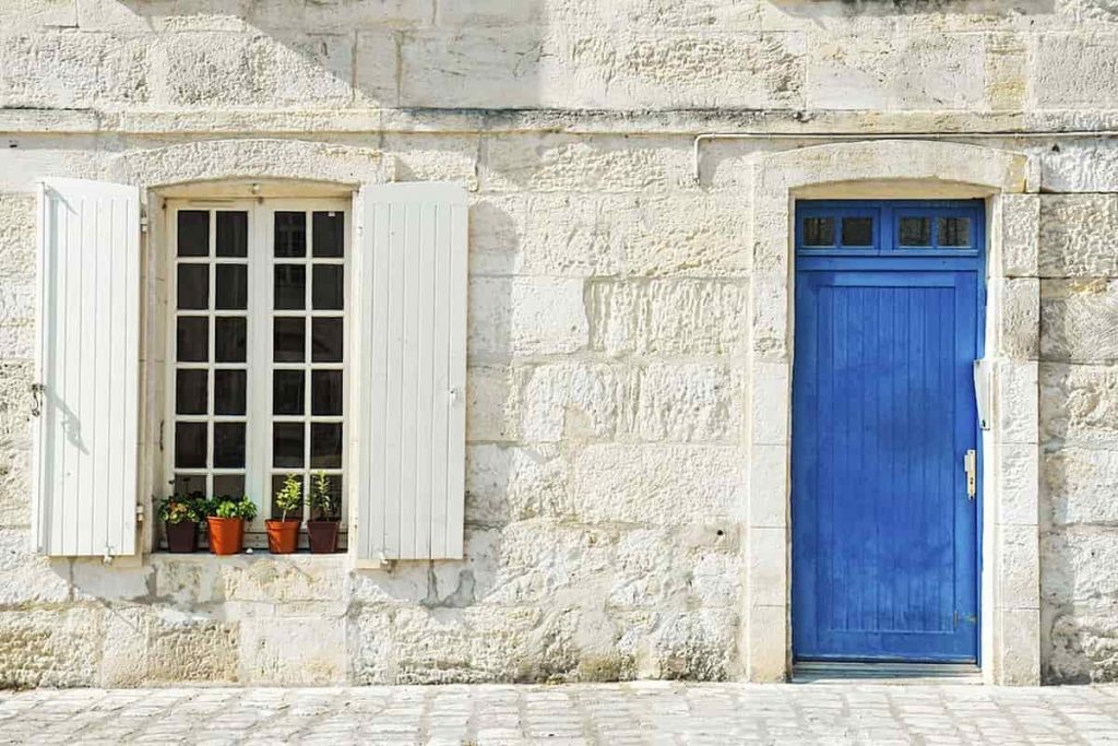 blue french front door next to a white window