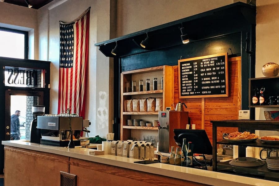 large american flag hang on wall next to a coffee bar