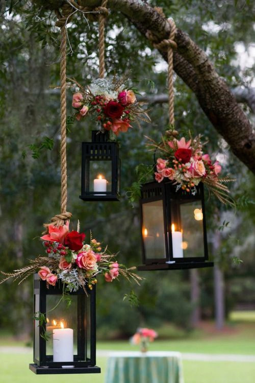 pink flower decorated hanging lanterns with candles inside