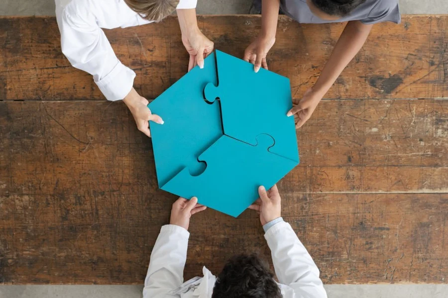 three people holding blue puzzle pieces