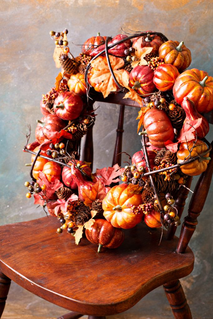 Festive autumn wreath with pumpkin and fall leaves